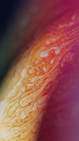 Chemical fluid. Bubble liquid. Defocused pink orange color fizzy texture paint mix wave on dark black light flare abstract art background.の写真素材