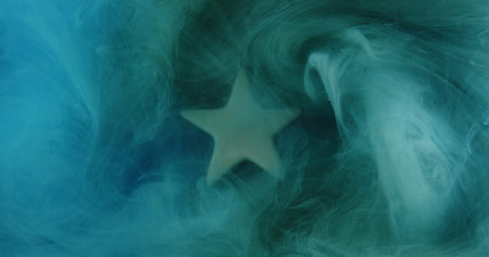 Shiny smoke cloud. Ink water. Blue green color vapor splash revealing star haze spreading abstract background.の写真素材