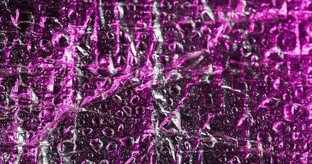 Pink drop. Flowing water. Pink humidity bubble film glossy surface. Condensation chaotic shimmering...