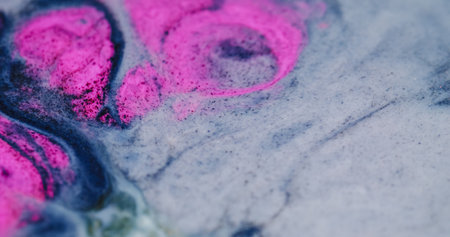 Fluid ink. Art reaction. Emergence of pink pigment on white enamel surface. Marble spread glitter...