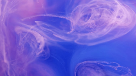 Atmospheric smoke. Sparkling water art. Defocused bright pink blue splash paint ink mist cloud moving on abstract blue background.の写真素材