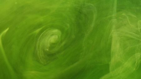 Smoke vortex. Paint fluid. Defocused bright green yellow cloud splash ink mist swirl flow wave moving on abstract art background.の写真素材