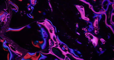 Petrol texture. Purple pink overflows. Spectral shade uneven surface. Glossy highlight dispersion puncture deformation connection stain.の写真素材