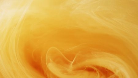 Shimmer fog. Shiny swirl. Defocused bright yellow orange cloud paint ink vapor steam mist vortex moving on abstract art background.の写真素材