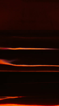 Damaged film overlay. Light leak. Ruined piece black fire orange red glitch artifacts scratches defect dark illustration art abstract background.の写真素材