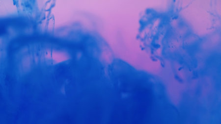 Bright mix drop. Splash steam. Defocused sparkling fluid blue color liquid magical smoky clouds on abstract pink art background.の写真素材