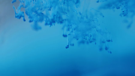 Color drop water. Magic spell. Defocused sparkling splash paint fluid bright flows blue liquid smoky...