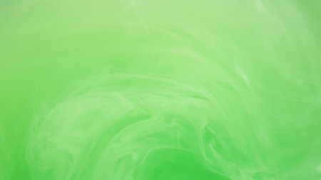 Light emulsion. Liquid paint. Defocused bright green color cloud ink mist vortex vapor steam moving on abstract art background.の写真素材