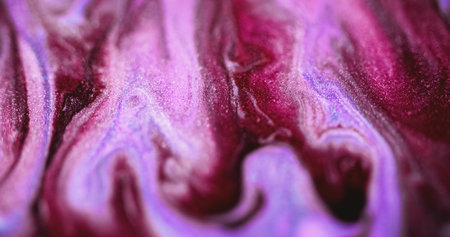 Shimmering fluid spill. Wet glitter flow. Defocused magenta pink purple color shiny particles...