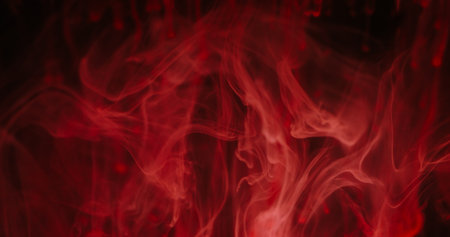 Paint water swirl. Blur liquid acryl. Defocused red colorful shine drops flow fluid smoke texture wave on abstract dark black background.の写真素材