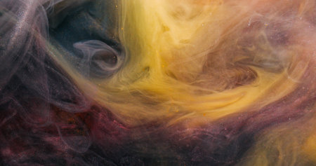Smoke splash. Steam flow. Black yellow golden pigment dissolve in water. Glitter abstract ink blend grunge color cloud blur background.の写真素材
