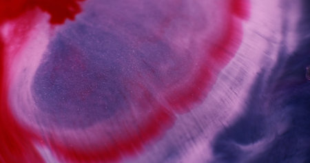 Liquid marble texture. Ripple fluid. Blur blue purple crimson color ink in acrylic water red drip spilling on abstract background.の写真素材