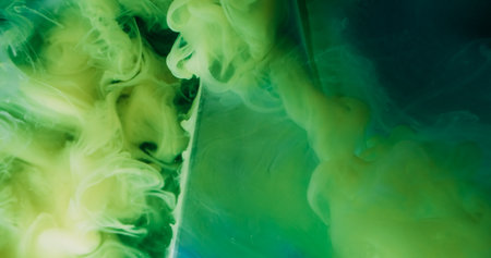 Swirling cloud. Color water. Defocused green blue paint in liquid geometric vapor on abstract acrylic creative dark black background.の写真素材
