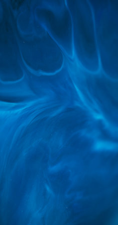 Defocused stream. Blue mix. Acrylic ink dissolving abstract swirl. Color enamel art emulsion curl wave pigment blur wet background.の写真素材