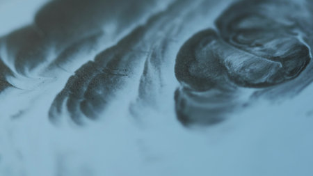 Paint pour. Emulsion flow. Defocused blue color substance pigment liquid blend fluid water texture spilling on abstract background.の写真素材