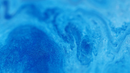 Ink particles. Acrylic fluid. Defocused blue color liquid chemical substance enamel marble water leaking on abstract art background.の写真素材