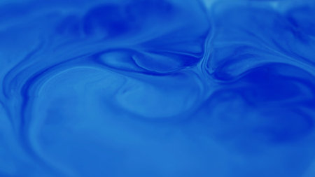 Bokeh art. Sparkling background. Defocused blue cyan color shiny paint wet shimmer water liquid floating on dark black abstraction.の写真素材