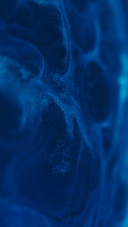 Ink grain. Shiny fluid. Blur blue color water texture dust sparkling mix flow spreading on abstract creative acrylic art background.の写真素材