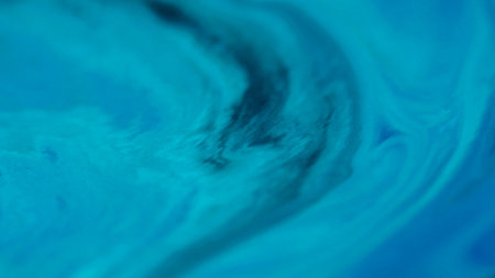 Wave ink. Enamel fluid. Defocused blue cyan stream water liquid flow dark black stains spreading on...