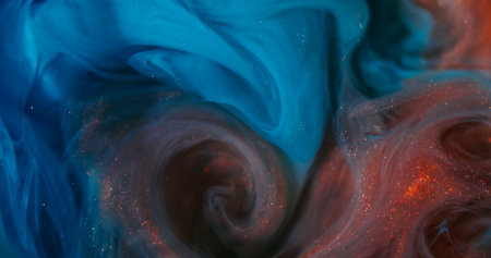 Paint mix. Shimmer cloud. Defocused blue orange colorful sparkling vortex splash glitter texture on abstract underwater background.の写真素材