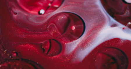 Ink bubbles. Oil texture. Defocused red purple white color acrylic fluid glitter round flow floating on abstract vibrant background.の写真素材