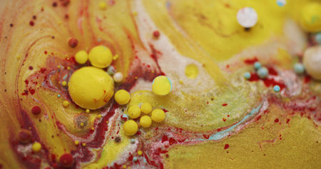 Spilling oil. Acrylic paint water. Blur yellow blue red color round bright glitter bubble floating on abstract creative background.の写真素材
