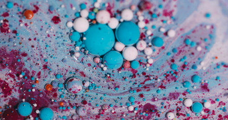 Shiny bubble flow. Ink spill. Defocused blue white purple colorful glitter oil round water floating on abstract art bokeh background.の写真素材