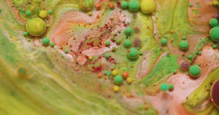 Bubble art. Ink water. Defocused green yellow red colorful round oil texture glitter acrylic flow...