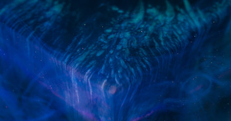 Paint leak. Blur sparkling flow. Color acrylic blob swirl mix on art cube. Sequin particles blue violet fluid abstract background.の写真素材