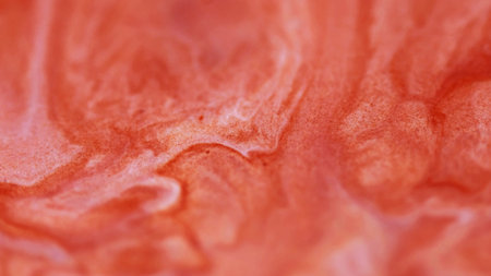Grain ink. Stream art. Defocused orange color marble surface water fluid liquid circling on abstract...