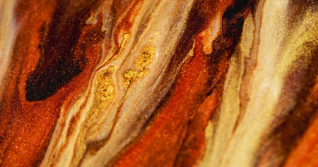 Glitter stream defocused. Shimmering mix. Yellow orange brown sparkling color particles blending on...