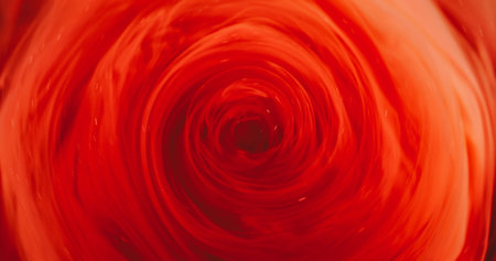 Paint vortex. Orange swirl vapor. Defocused bright red color glitter acrylic fume smoke round texture twirl on abstract light background.の写真素材