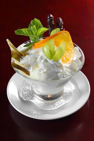 Ice cream in a glass cube with fruitsの写真素材