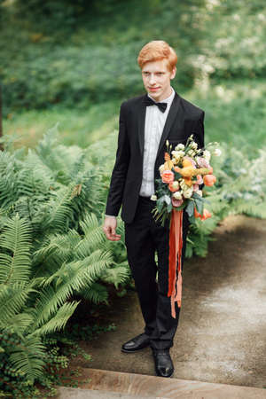 groom with flowersの写真素材