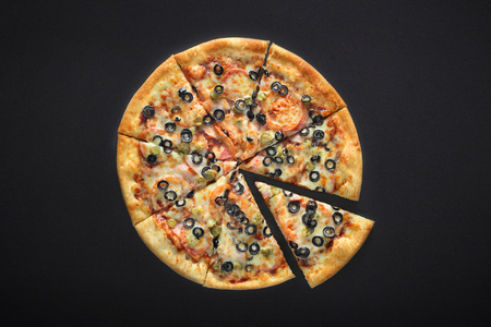 pizza barbecue with cornichoni olives peperoni cheese mozzarella on black stone backgroundの写真素材
