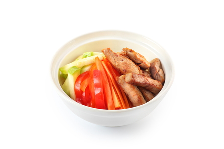 vegetables with pork on a plate on a white background isolatedの写真素材