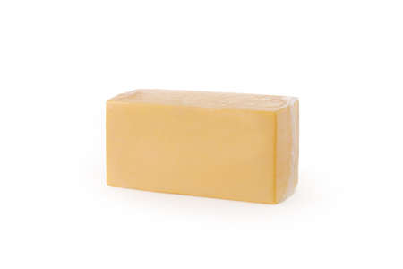 Large rectangular piece of cheese on white background isolatedの写真素材
