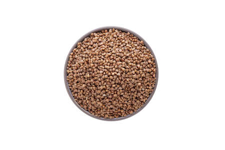 Raw buckwheat in bowl on white background isolated. Top viewの写真素材