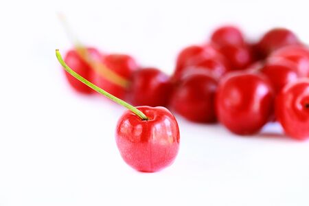 Fresh cherries in glass bowl isolatedの写真素材