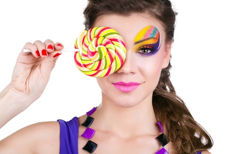 portrait of a glamourous beautiful woman holding lollipopの写真素材