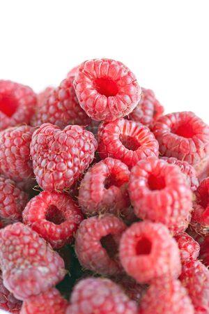 Bowl of raspberries on wooden table close upの写真素材
