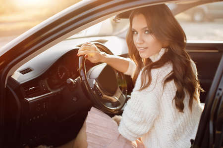 Pretty young woman sitting in the carの写真素材