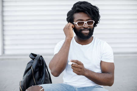 portrait of a handsome happy black man with wireless headphonesの写真素材