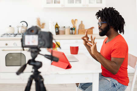 Handsome man recording video business course at home
