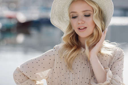 Portrait of a young smiling woman in hat outdoorの写真素材