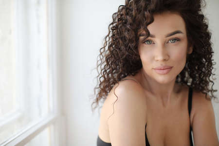 Close up portrait of a young beautiful woman on white backgroundの写真素材