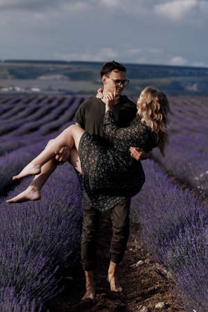 happy fashion woman and man outdoors at lavenderの写真素材