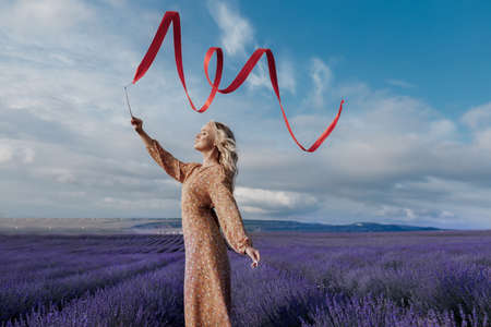 fashion portrait of a young pretty woman in lavender fieldの写真素材