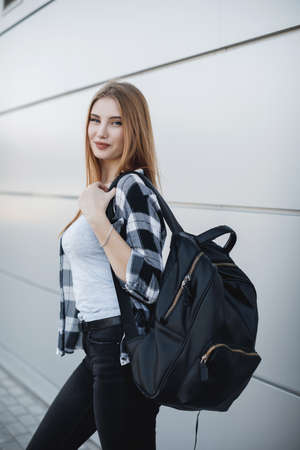 Young fashion woman outdoors near gray backgroundの写真素材