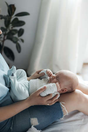 happy mother with little cute newborn at home